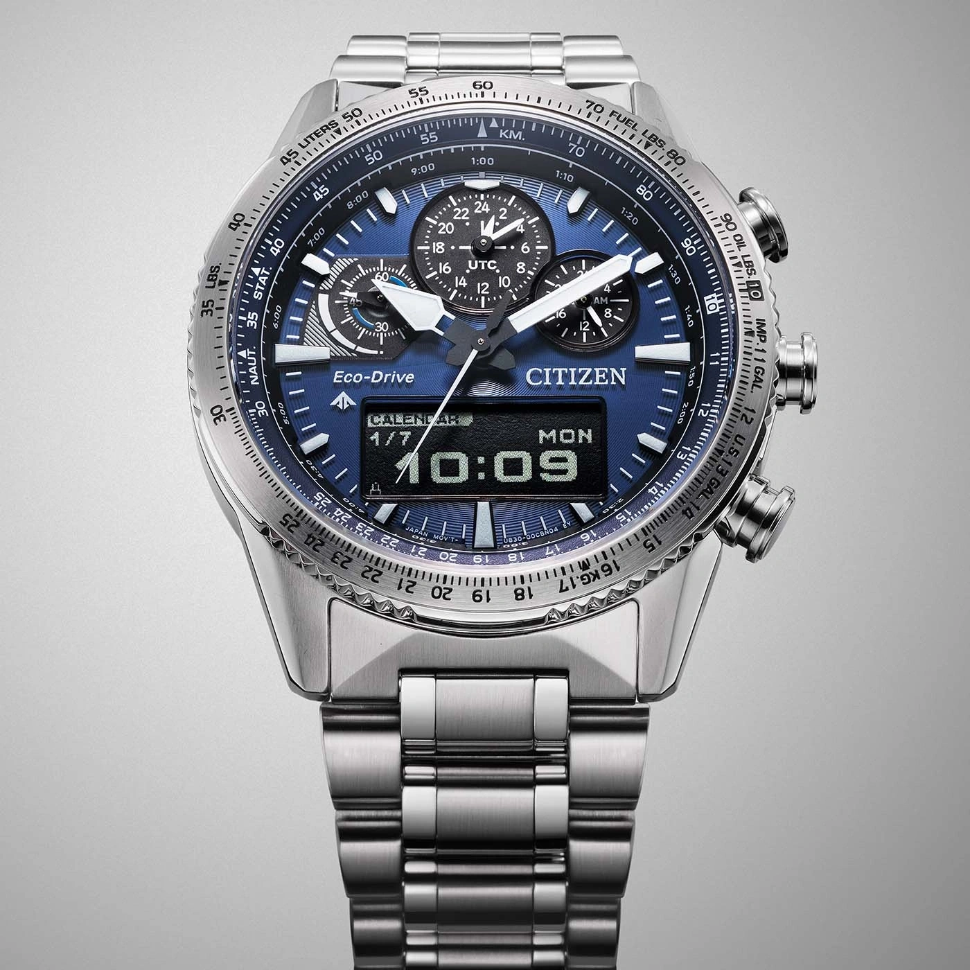 Citizen watch with blue face, calendar, and multiple dials, stainless steel band.