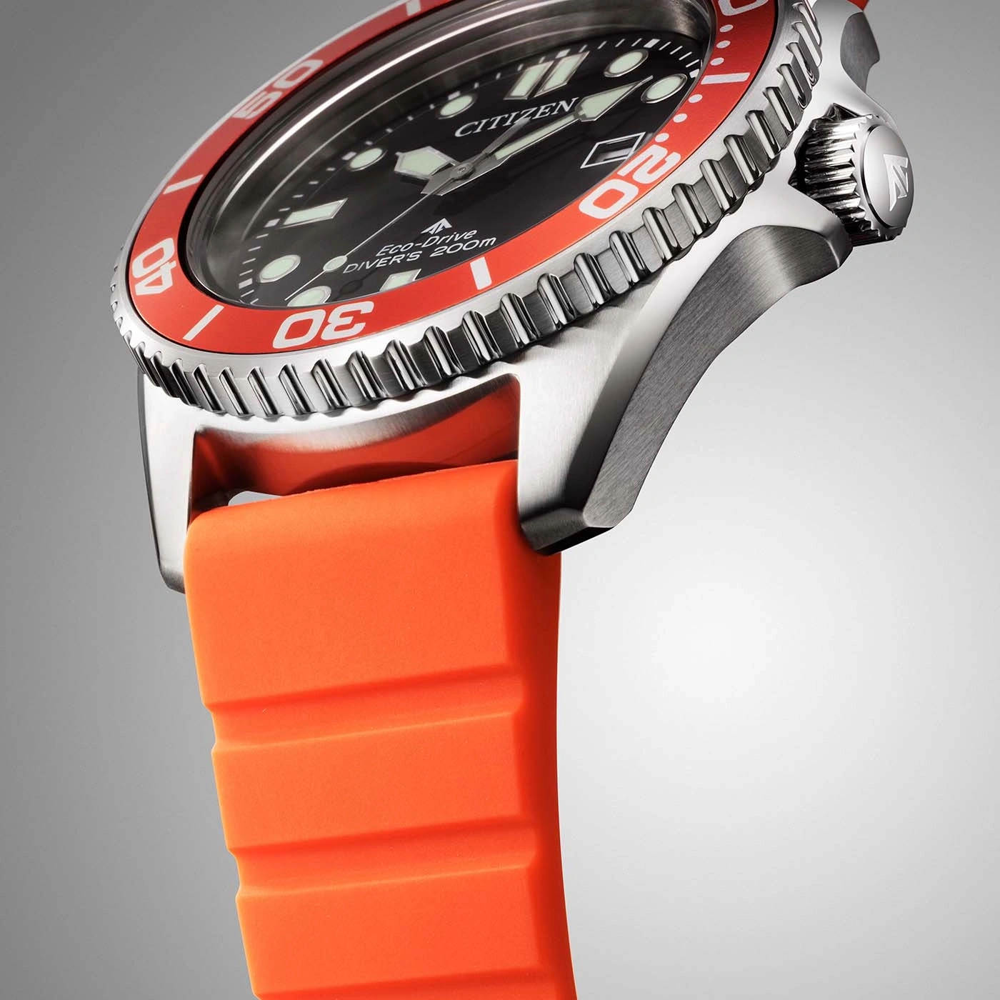 Close-up of a Citizen Eco-Drive diver's watch with an orange strap.