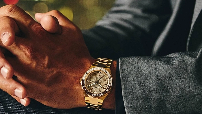 Man wearing a gold watch, close-up shot, luxury timepiece, wrist