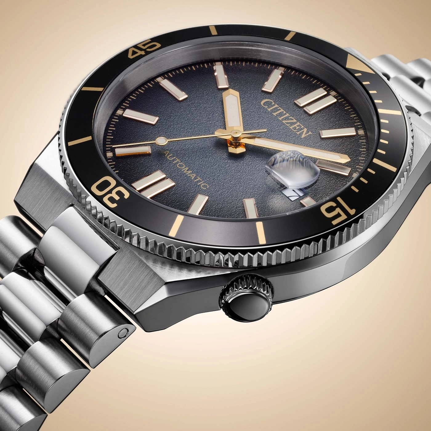 Close up of a Citizen automatic watch with a black dial and gold accents.