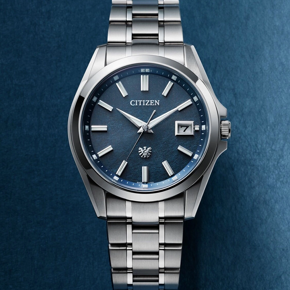 Citizen watch with a blue face and silver band on a blue background.