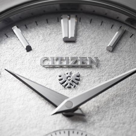 Close-up of a Citizen watch face with silver hands and markers.
