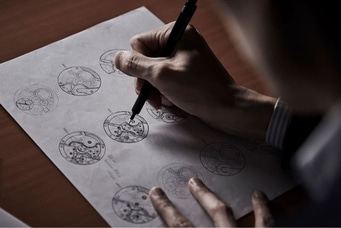 A person sketching watch designs on paper with a pen, close-up shot.
