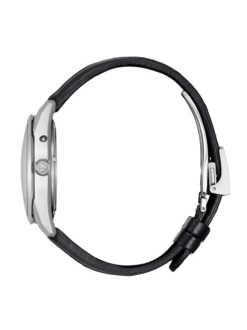 Side view of a silver watch with a black leather strap on green background.