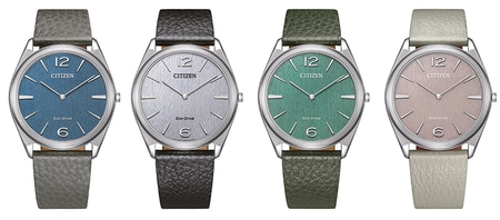 Four Citizen watches with different colored faces and leather straps, elegant design.