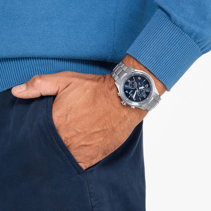 Man wearing a watch, blue sweater, hand in pocket, close-up shot