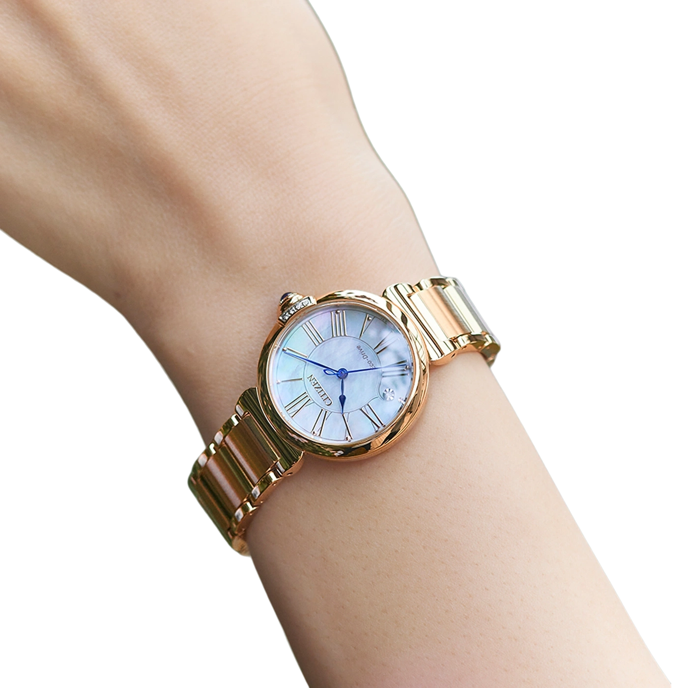 Wrist watch on a wrist, gold, Citizen, blue hands, white face, Roman numerals
