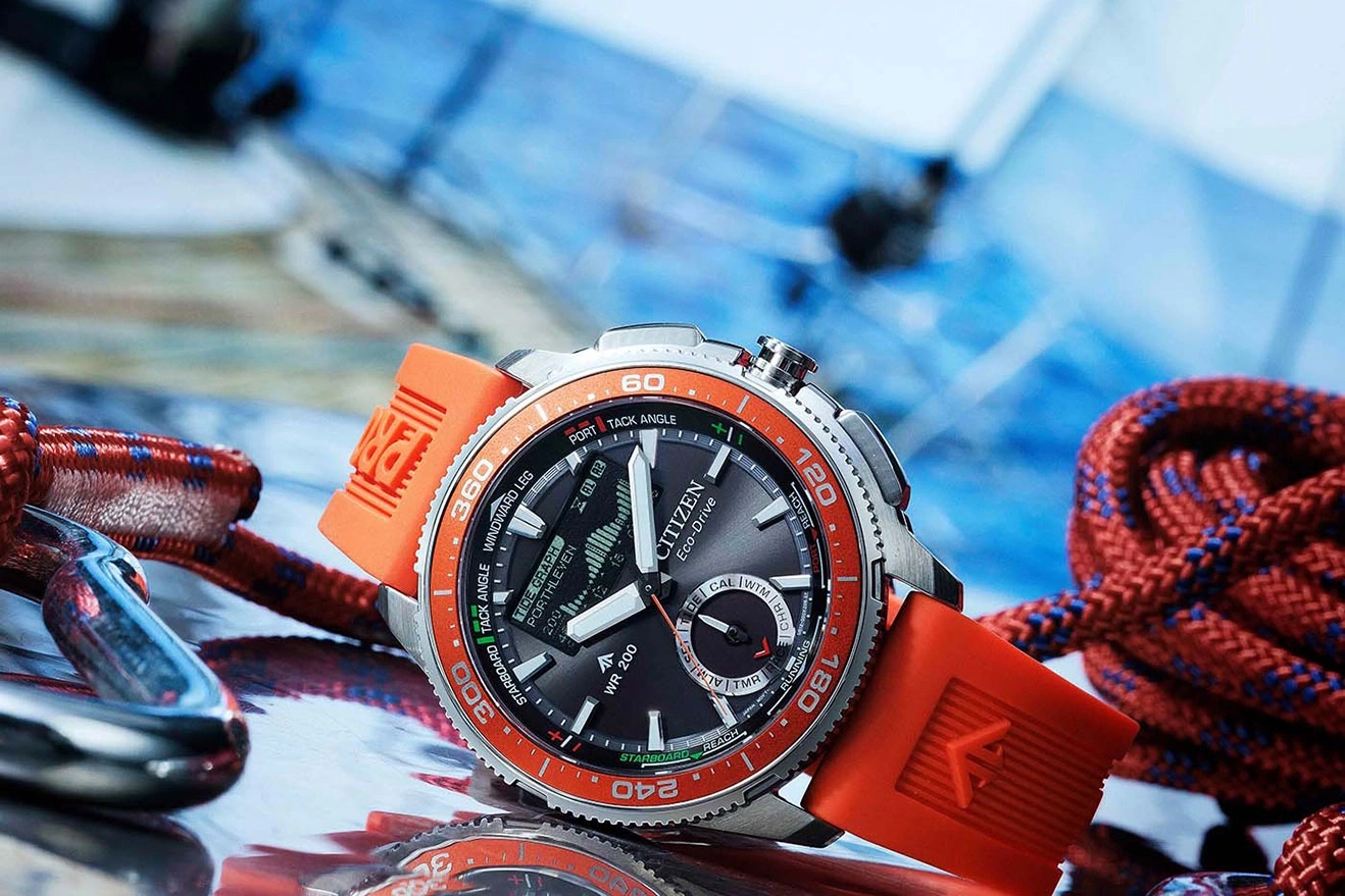 Citizen Eco-Drive watch with orange strap and nautical elements.