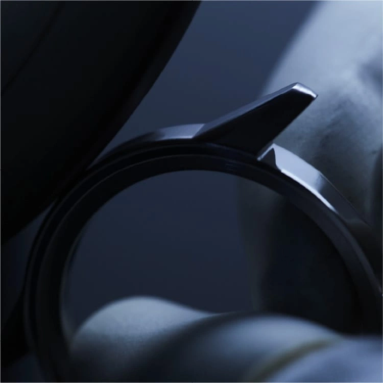 Close-up of a watch with a shiny metal band and details.