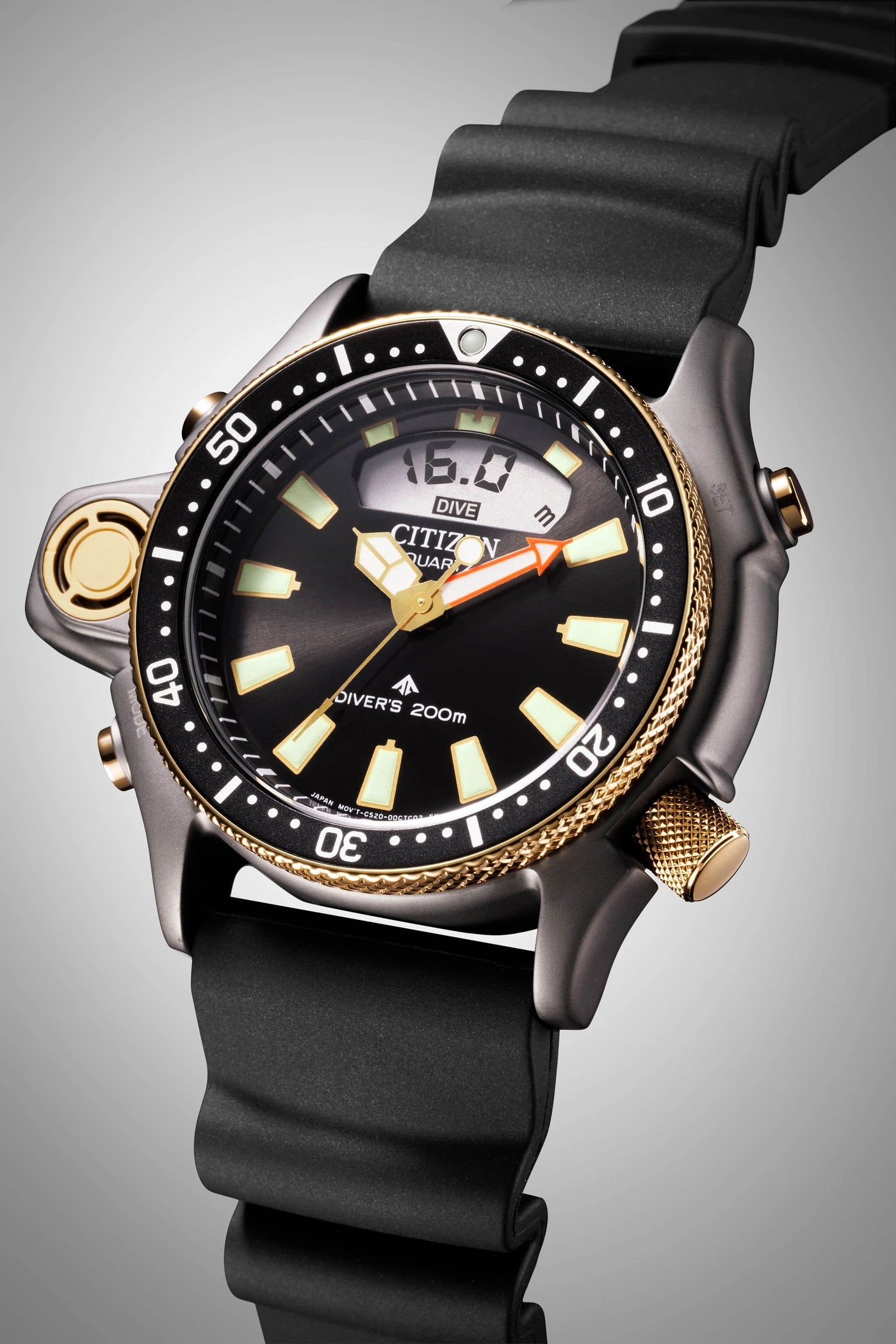 Close-up of a Citizen dive watch with a black strap and gold accents.