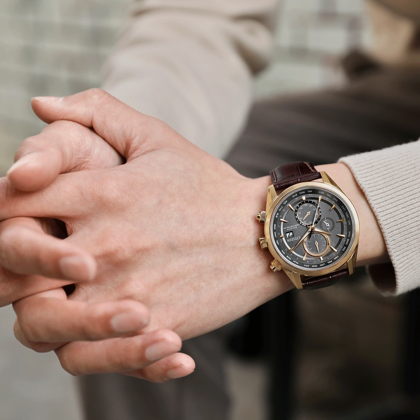 Man wearing a gold Citizen watch with a brown leather strap