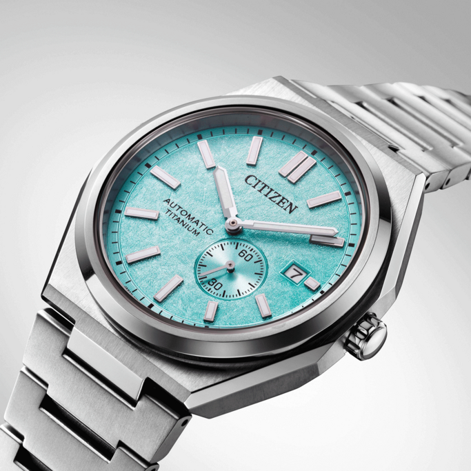 Citizen watch with a turquoise face and titanium bracelet, elegant design.
