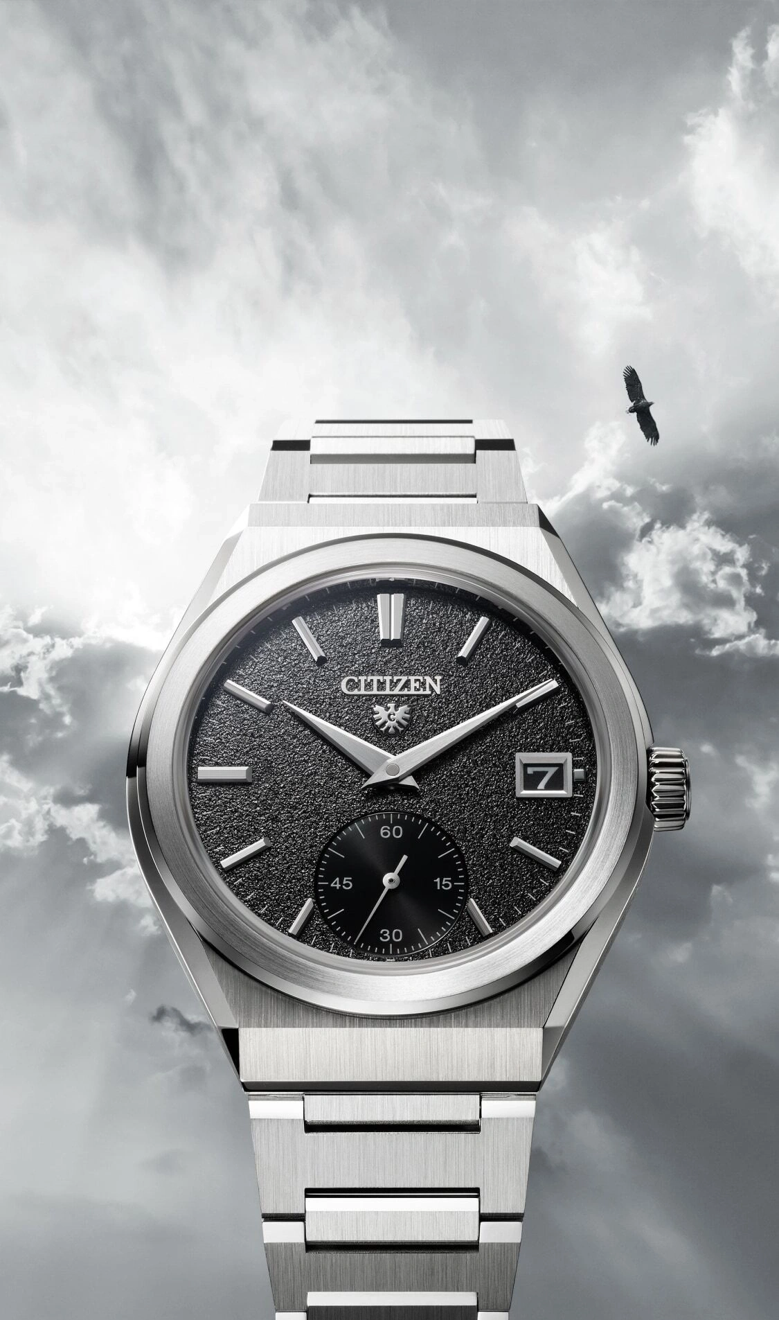 Citizen watch with a black face, silver band, and an eagle in the sky.