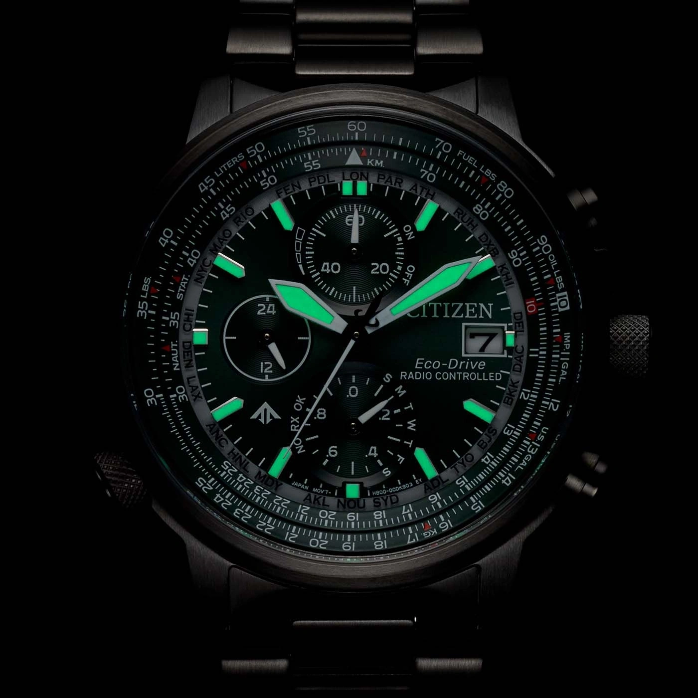 Close-up of a Citizen Eco-Drive watch with glowing green accents and detailed dial.