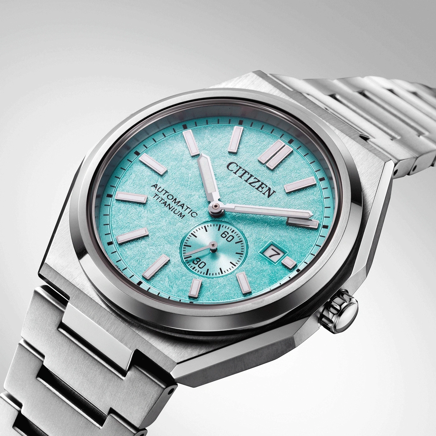 Citizen watch with a turquoise face and titanium bracelet, elegant design.