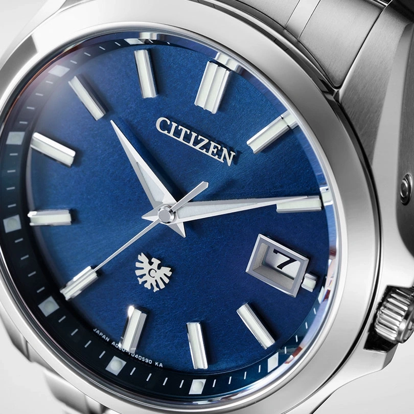 Citizen watch with a blue face, silver hands, and a date display at 3 o'clock.