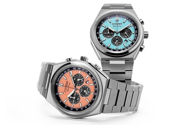 Two Citizen watches with blue and orange faces, titanium, Eco-Drive, and chronograph features.
