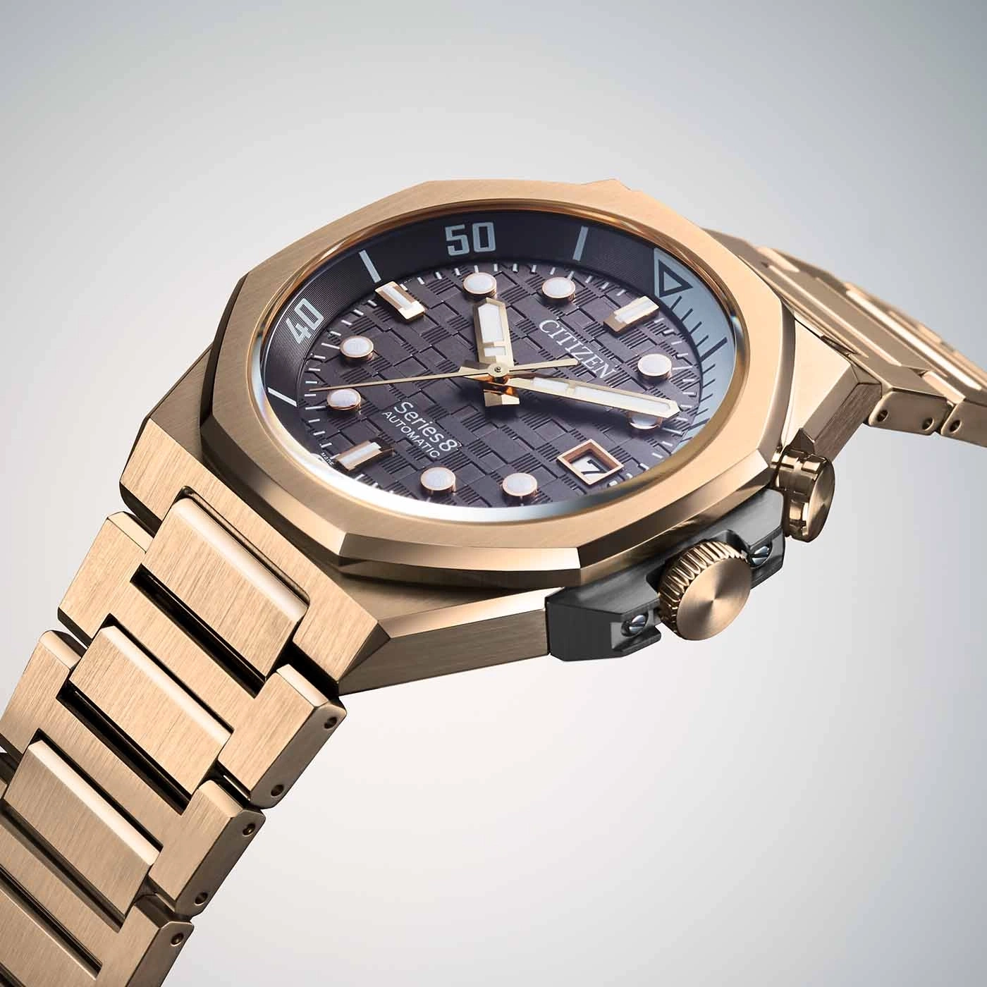 Close-up of a gold Citizen Series 8 automatic watch with a textured dial.