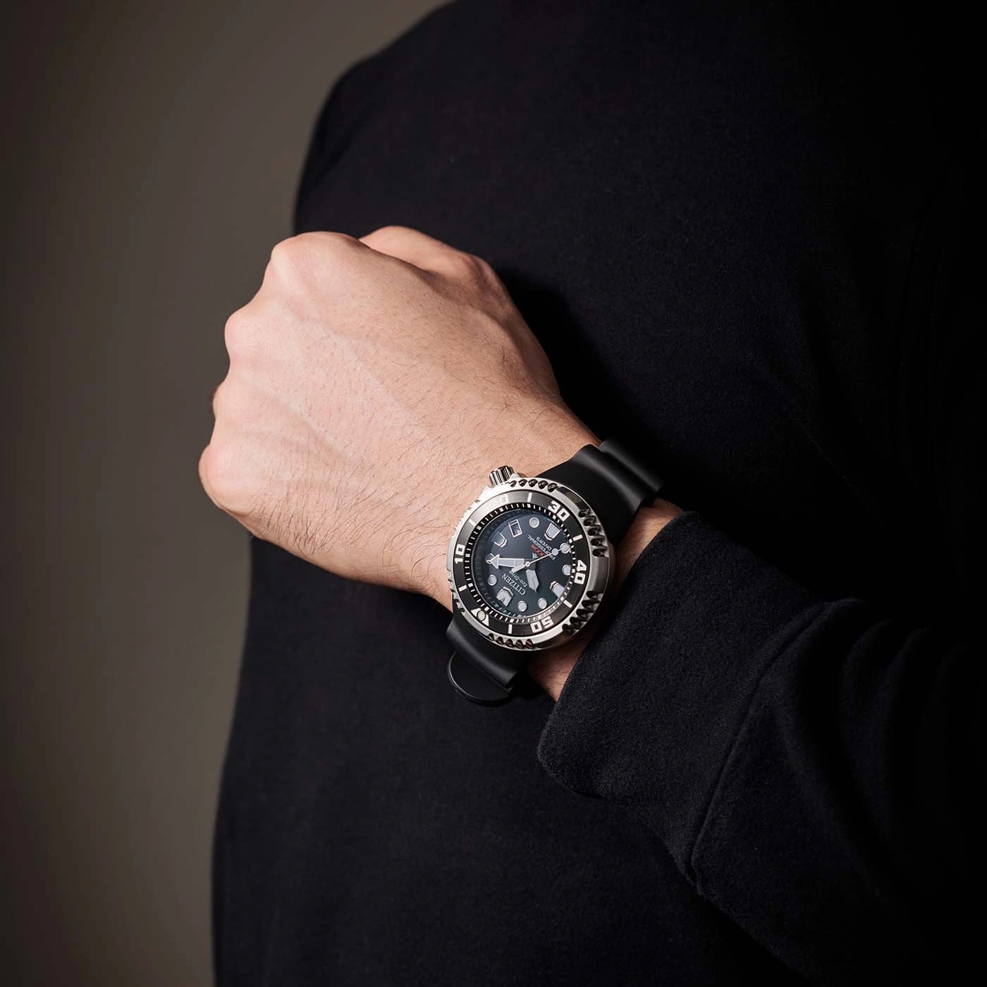 Man wearing a black watch on his wrist, close-up shot.