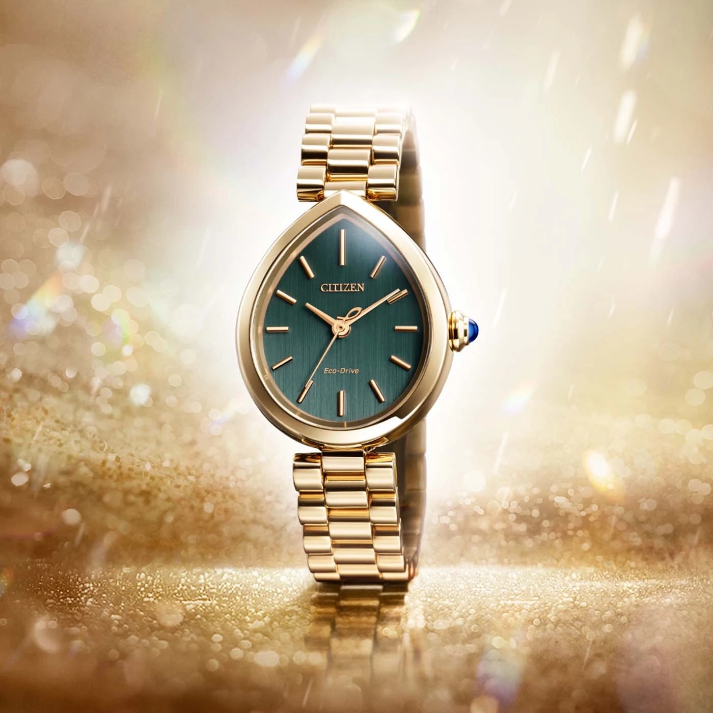 A gold Citizen Eco-Drive watch with a green face.