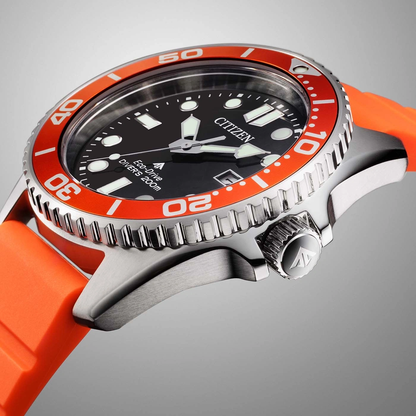 Close-up of a Citizen Eco-Drive diver watch with an orange bezel and strap.