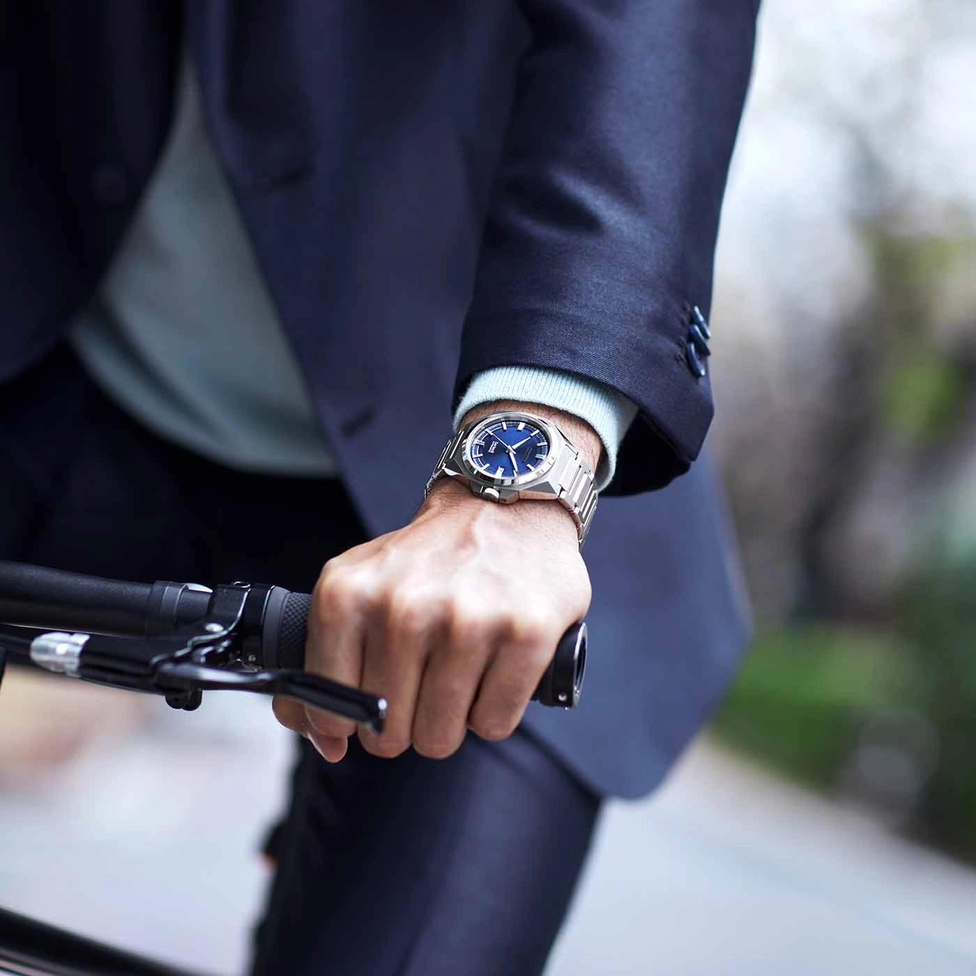 Man wearing a watch while riding a bicycle, close-up shot.