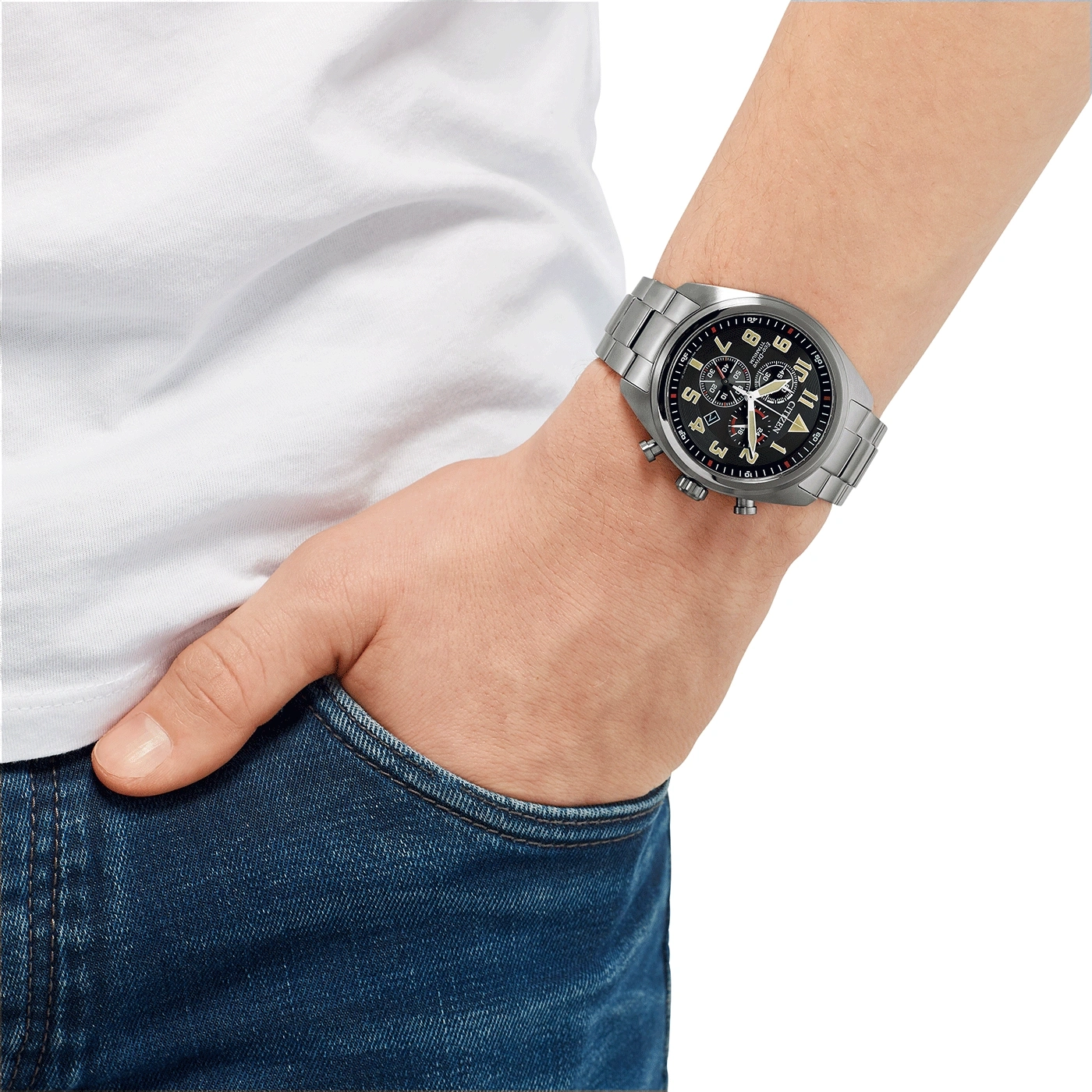 Man wearing a silver watch, white shirt, and blue jeans.