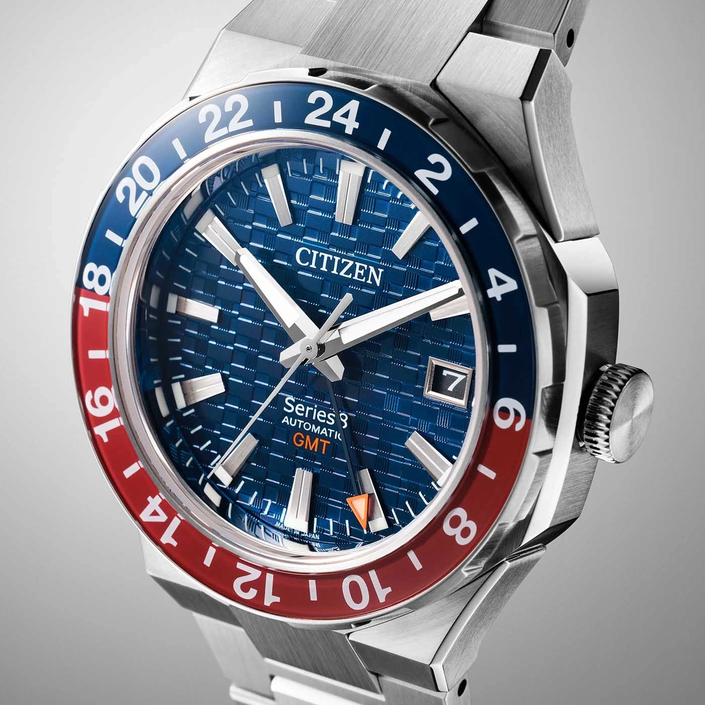 Citizen Series 8 GMT watch with blue and red bezel and date display.
