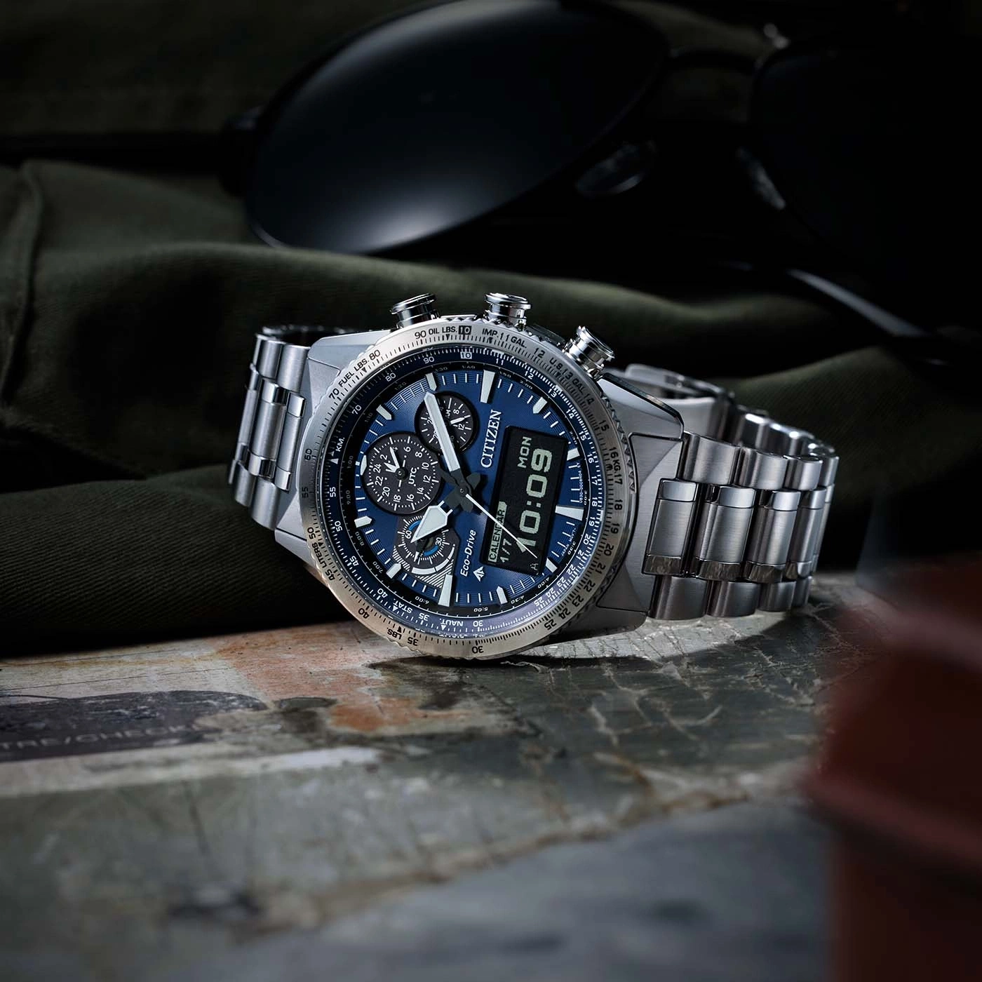 Close-up of a Citizen watch with a blue face and metal band.