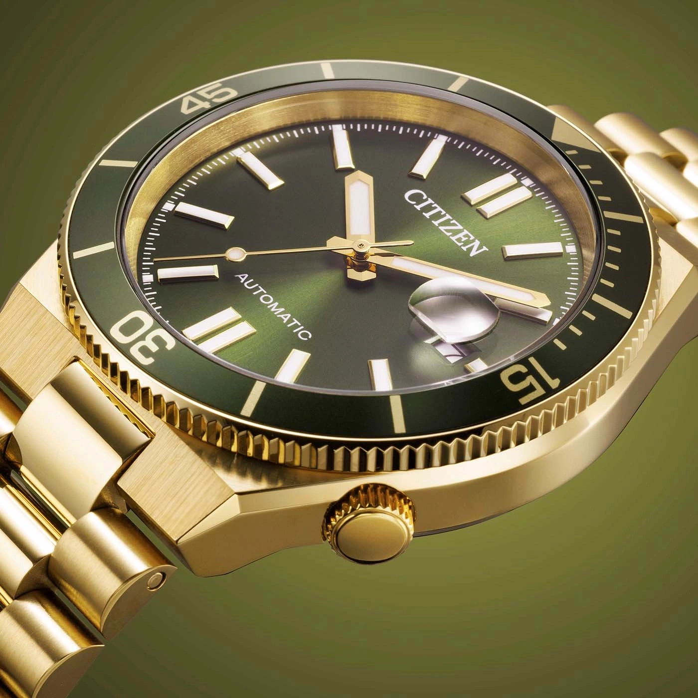 Close-up of a gold Citizen automatic watch with a green dial and bezel.