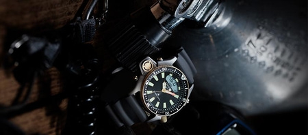 Close-up of a diving watch with a black dial and digital display.