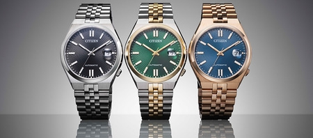 Three Citizen watches with different colored faces and metal bands.