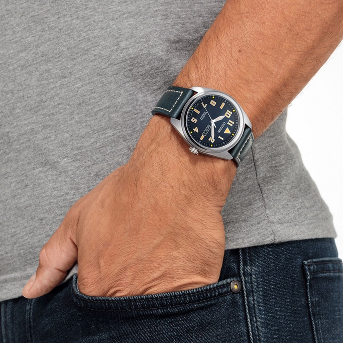 Man wearing a Citizen watch, with a blue strap, in a pocket.