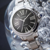 Citizen watch with black face and silver band, close-up shot.